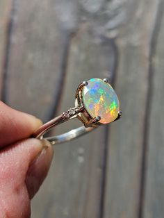 This exquisite Ethiopian opal ring features (4) genuine diamonds, inset in the band! Solid sterling silver and oh, so fab! The perfect engagement ring, baybay! Opal And Diamond Ring, Ethiopian Opal Ring, The Perfect Engagement Ring, Perfect Engagement Ring, Opal Ring, Ring Size 7, Opal Rings, Ethiopian Opal, Diamond Ring