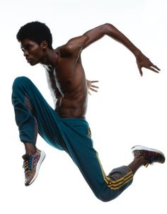 a young man is jumping in the air with his feet up and one leg bent