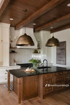 an image of a kitchen setting with two pendant lights over the island and sink area