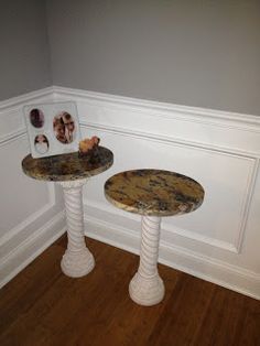 two marble tables in the corner of a room