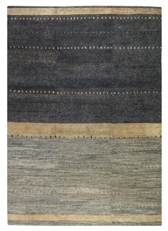 an area rug with different colors and patterns on the floor, including black, grey, beige