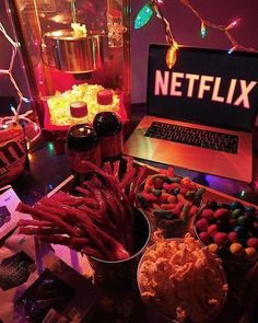 a laptop computer sitting on top of a table filled with candy and candi canes