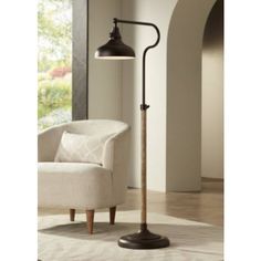 a lamp that is sitting on top of a floor next to a chair and window