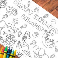 a happy birthday coloring page with crayons and colored pencils next to it