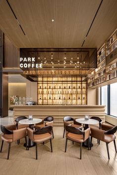 an empty restaurant with wooden tables and chairs