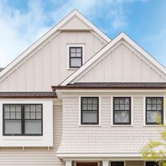 a house with white siding and black windows