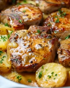 some meat and potatoes are in a pot