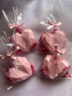 four pink heart shaped cakes wrapped in plastic