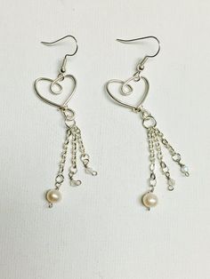 Silver plated wire heart triple silver plated chain dangling earrings with white freshwater pearls and glass Crystal beads. The silver plated earring hooks, chain, and wire are nickel free and tarnish resistant. These elegant  earrings make the perfect gift for a loved one! Made in Hawaii. Earring Inspo, Funky Rings, Wire Heart, Bead Earring, Bijoux Fil Aluminium, Soldering Jewelry, Dangling Earrings, Jewelry Inspo, Pretty Jewellery