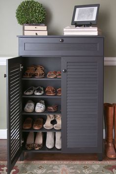 a shoe cabinet with several pairs of shoes in it