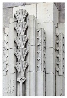 an art deco architectural design on the side of a building in black and white photograph