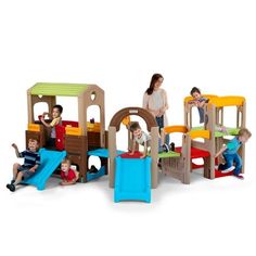 several children playing in a play area with slides and climbing structures, including a toddler's slide