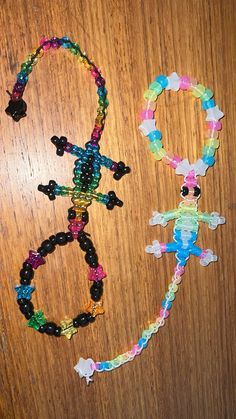 two bracelets made out of plastic beads on a wooden table next to each other