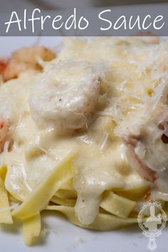 a white plate topped with pasta covered in sauce