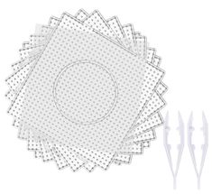 four pieces of white paper with dots on them and three forks in the background,