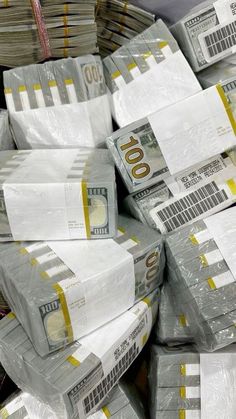 stacks of $ 100 bills wrapped in plastic and sitting on top of each other at a warehouse