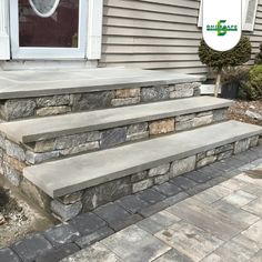 stone steps leading up to the front door of a house