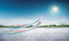 an image of colorful balloons flying in the sky over a large open space with concrete flooring