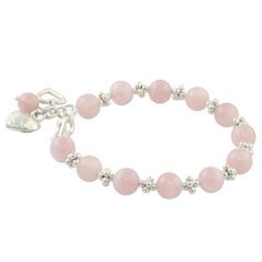 a pink beaded bracelet with silver beads and a heart charm on the clasp closure