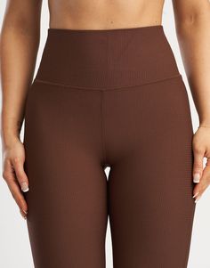 The Flare Waffle Pants are an iteration of the ever popular Flare Leggings with a new waffle pattern fabric. With a perfected length, width and comfort plus the super soft feel of the waffle fabric offers everything you need in a street-to-gym yoga pant - High Waisted: To keep you feeling secure - Flexible Waistband: Designed to lie flat on your skin - Additional Rear Zip Pocket - Super comfy ribbed fabrication - Designed for high movement activities, as well as leisure 81% Nylon, 19% Spandex Be High Waist Brown Leggings For Loungewear, Brown High Waist Yoga Pants, Brown Bottoms With Elastic Waistband For Yoga, Brown Yoga Bottoms With Elastic Waistband, Brown High Waist Yoga Leggings, High Waist Brown Yoga Bottoms, High Waist Brown Yoga Leggings, High Waist Brown Yoga Pants, Chestnut Brown