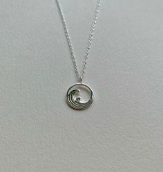 Wave Necklace, Ocean necklace, water element, ocean wave pendant, sterling silver, Beach lover, surfer gift, boho, birthday gift, sea, surf Presenting  a dainty and delicate sterling ocean wave pendant suspended from a 18 inch trace chain with a lobster fastening. Dimensions: Height: 12 mm Width: 11 mm Both necklace and chain are stamped with the 925 sterling silver hallmark guarantee. Would make a lovely birthday or ChristmasDay gift for a nature or ocean lover and can include gift wrapping and Minimalist Sterling Silver Jewelry For Beach, Wavy Sterling Silver Beach Jewelry, Sterling Silver Wavy Necklace For Gifts, Silver Wavy Necklace For Gift, Everyday Silver Jewelry With Wavy Design, Everyday Silver Jewelry With Wavy Shape, Everyday Silver Wavy Jewelry, Wave Pendant, Ocean Necklace