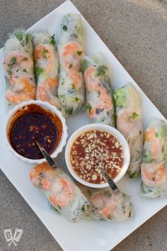 a plate with shrimp rolls and dipping sauce