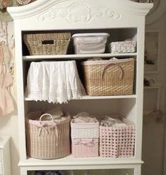 a white shelf with baskets on top of it