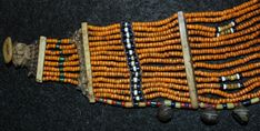 "Choker 609. Authentic Konyak Naga patterned bead choker. Festival choker of less common light mustard beads with interesting z shaped patterning of bead work in center sections. Bone separators provide structure to the unique piece. The piece is 16 inches long, has 15 strands of beads, and is in excellent condition for its use and age which is the early to mid 19th century. Please note that the designation \"Authentic\" means that the piece was made by the Nagas and used by them in their actual Traditional Large Beads For Choker, Traditional Brown Jewelry With Tiny Beads, Traditional Orange Beaded Bracelets With Polished Beads, Traditional Orange Beaded Necklace With Tiny Beads, Traditional Yellow Beaded Bracelets With Polished Beads, Traditional Orange Necklaces With Tiny Beads, Traditional Small Orange Beads, Traditional Tiny Orange Beads, Konyak Naga