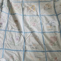 a child's quilt with many drawings on it