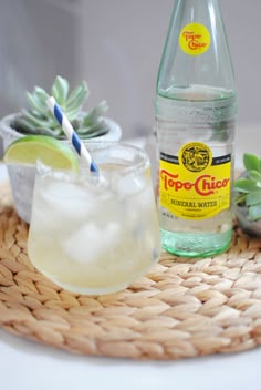 a bottle of topo tea next to a glass filled with lemonade