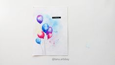 a watercolor painting of colorful balloons on a white wall