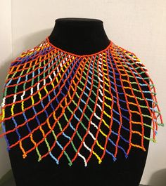 Beautiful, Multicolored beaded Egyptian/African/Multicultural Collar Necklace. Made of intricate seed beads with an adjustable ball closure. Necklace length 16 inches, Height 8 inches, Width 26 inches. Multicolor Traditional Bib Necklace With Large Beads, Adjustable Colorful Beaded Necklace For Festivals, Adjustable Multicolor Beaded Necklaces With Large Beads, Adjustable Multicolor Beaded Necklace With Large Beads, Traditional Multicolor Tiny Beads Choker, Traditional Multicolor Beaded Choker, Unique Orange Beaded Necklace, Traditional Colorful Beads Bib Necklace, Traditional Multicolor Choker With Large Beads