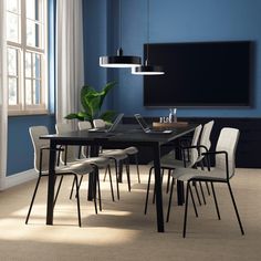 a dining room with blue walls and white chairs