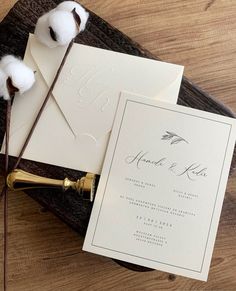 the wedding stationery is laid out on top of the table with cotton floss