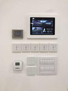 the control panel on the wall has buttons, switches and other electronic devices attached to it