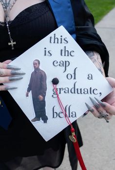 a person holding a graduation cap with the words, this is the cap of a graduate