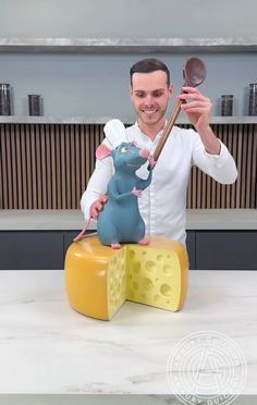 a man standing in front of a mouse on top of cheese