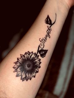 a woman's arm with a tattoo that says strength and a sunflower on it