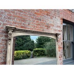 an old brick building with a large mirror on it