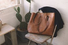 The Vintage Tote Bag Vintage Weekender Bag With Leather Lining, Vintage Soft Leather Weekender Bag For Everyday, Vintage Everyday Tote Bag, Vintage Leather Shoulder Bag With Rolled Handles, Classic Brown Bag With Rolled Handles, Brown Travel Satchel With Rolled Handles, Vintage Soft Leather Everyday Bag, Brown Satchel With Rolled Handles For Travel, Chic Everyday Satchel With Leather Backing