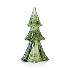 a green glass christmas tree sitting on top of a table