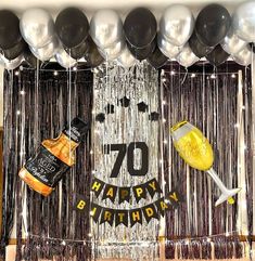 a 70th birthday decoration with balloons and confetti