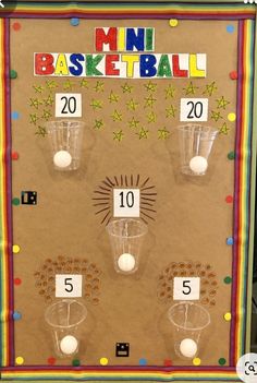 a bulletin board with numbers, cups and balls in front of the words mini basketball