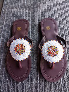 Unique Gift | Sandals | Gladiator Sandals | Greek Sandals | Beach Jewelry | Wedding Shoes | Leather Sandals | Custom | Mothers Gift An elegant and authentic pair of African inspired beaded ladies sandals, with a unique and eye-catching design. 100% genuine leather. Color - Multicolor.   *100%  Handmade.    S I Z E  C H A R T  EUUSAUKCMINCHES 343.51.522.38.8 354.52.5239 365323.69.3 376424.29.5 387524.99.8 398625.510 4096.526.110.3 4110726.810.6 4211827.510.8 4312928.211.1   ♥ you could also find White Beaded Sandals With Round Toe, White Beaded Open Toe Sandals, Traditional Beaded Flip Flops With Round Toe, African Print Shoes, Beaded Leather Sandals, African Sandals, Fancy Sandals, Beach Wedding Jewelry, Beaded Shoes