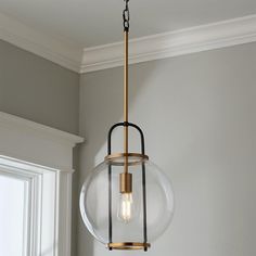 a light fixture hanging from the ceiling in a room with gray walls and white trim