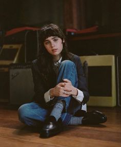 a woman sitting on the floor with her legs crossed