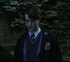 a young man wearing a harry potter outfit