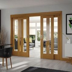 a living room filled with furniture and lots of glass sliding doors that open up to the outside