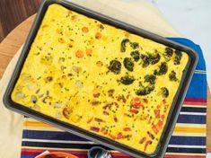 a casserole dish with broccoli and cheese in it on a table