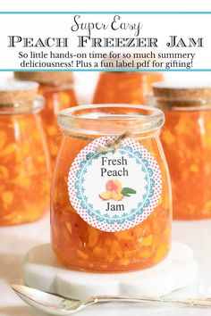 jars filled with peach freezer jam sitting on top of a table